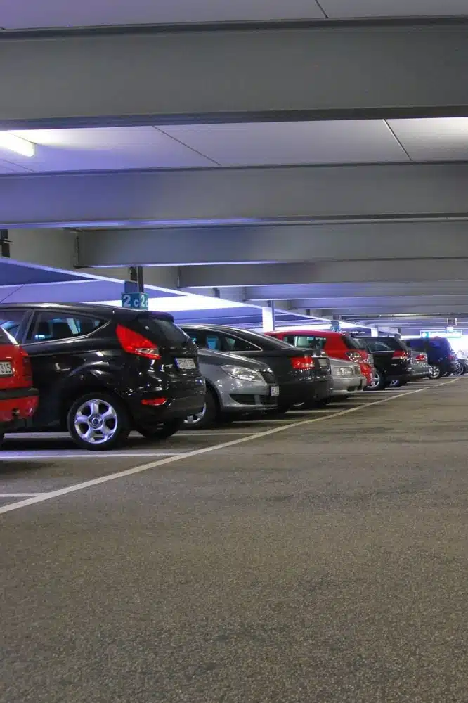 inside of a parking garage showing a row of vehicles